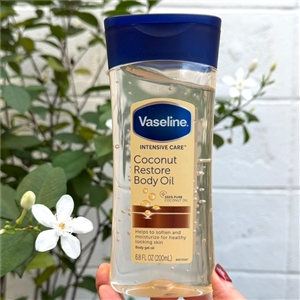 เหลือง Vaseline Intensive Care ** Coconut Restore Body Oil 200ml.